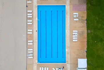 Aerial view of a swimming pool treated with pool maintenance chemicals