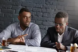 Two business advisors discussing a hygiene services plan